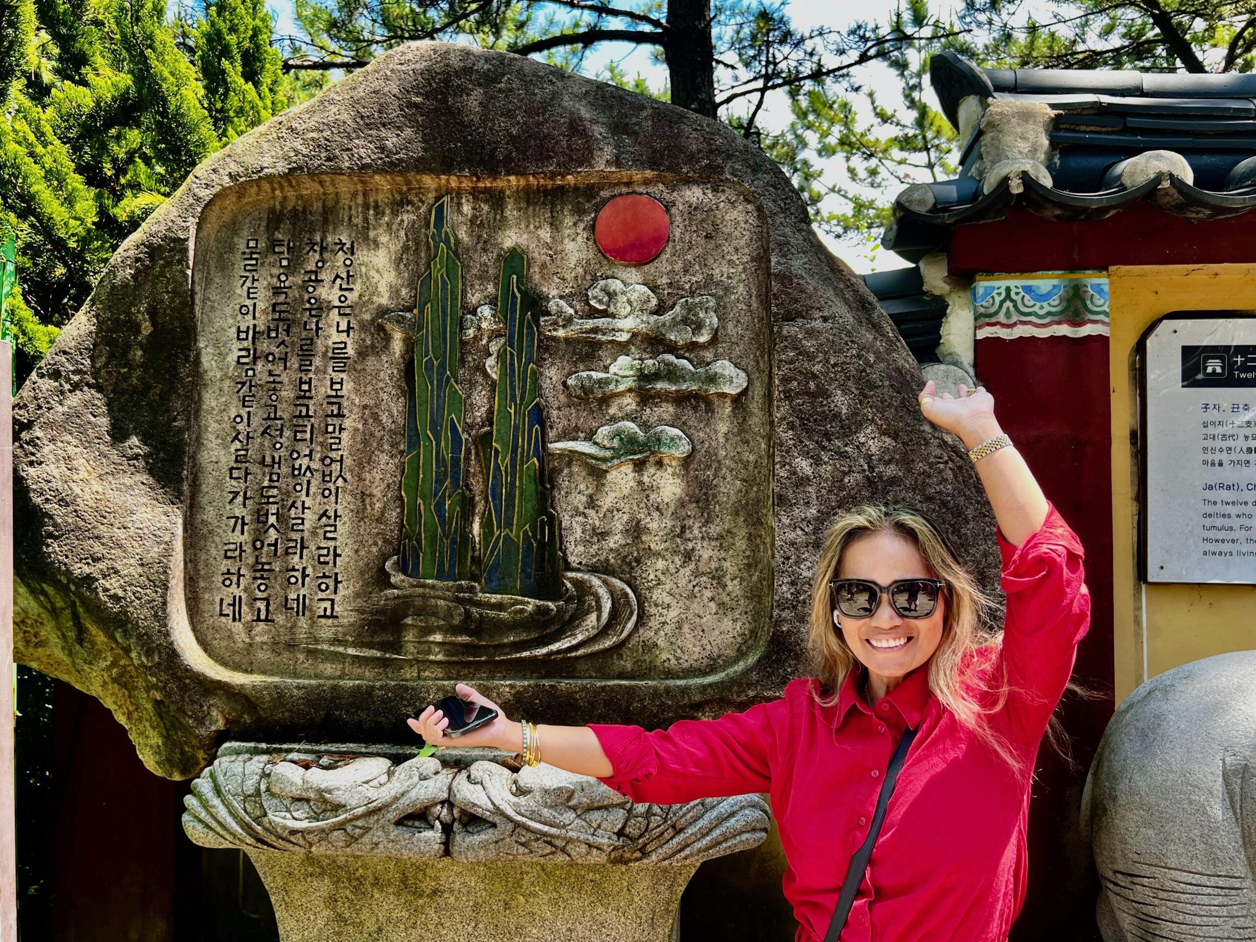 Aidalyn posing beside a traditional stone monument in South Korea.