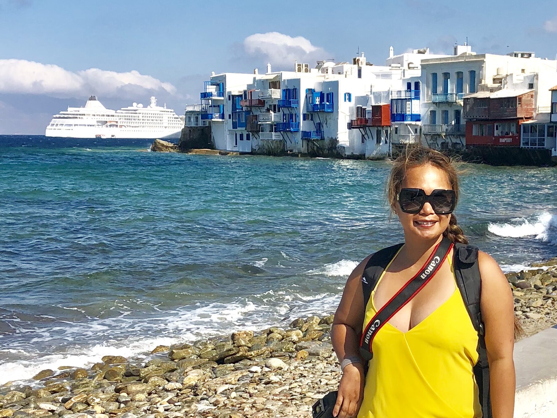 Visiting Mykonos Greece with white waterfront buildings and the Aegean Sea