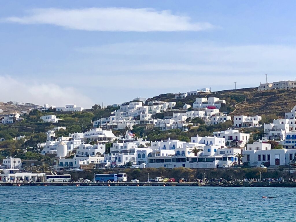 Whitewashed houses on the hillside overlooking the sea in Mykonos Greece